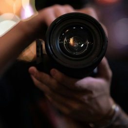 person holding black camera lens