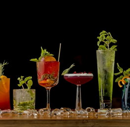 a table topped with lots of different types of drinks